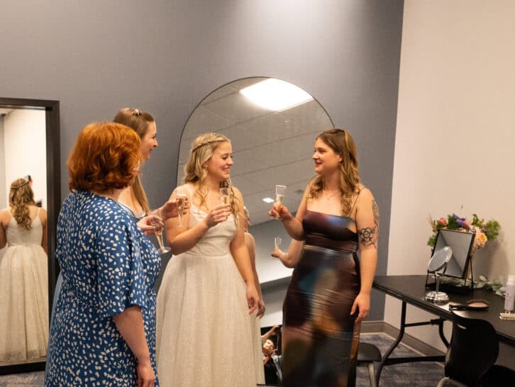 Group of women at Lowell Observatory social event, talking and holding drinks.