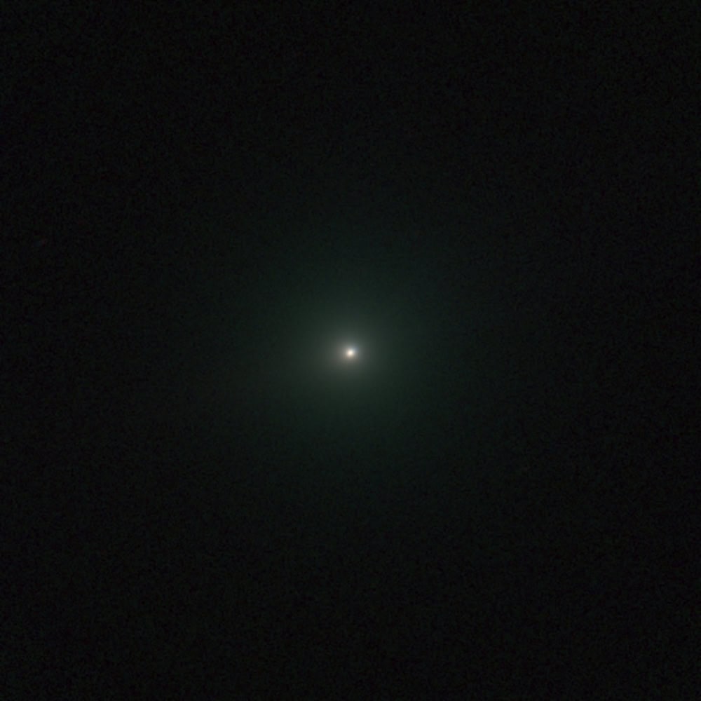 Comet 3I/ATLAS visible with a bright nucleus and faint tail in dark sky.
